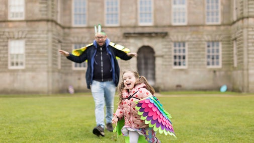 Families exploring the Easter Adventures Trail in the park at Lyme, Cheshire
